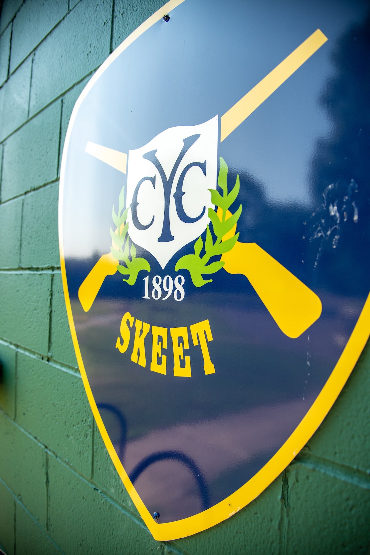 YCC Skeet 1898 Logo on Green Wall Alt Angle