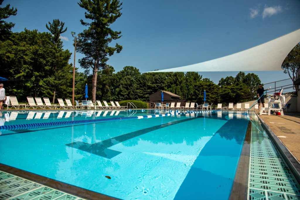 YCC Swimming Pool with Trees and Blue Sky in Background